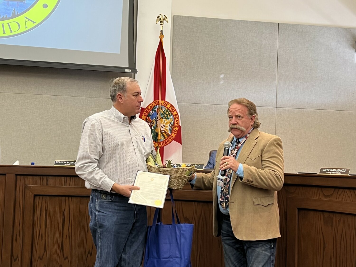 OKEECHOBEE -- Micky Bandi of Florida Farm Bureau (left) accepted the City Farm Week proclamation from Commissioner Brad Goodbread (right) at the Nov. 9 commission meeting.